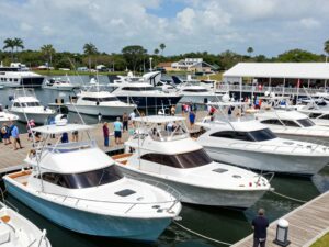 A display of various boats at the Charleston Boat Show with attendees exploring the vessels.