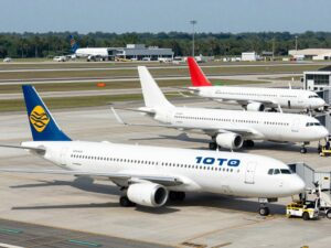 Exterior view of Charleston International Airport with airplanes and passengers.