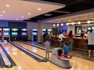 A modern entertainment venue showcasing a bowling alley and arcade games
