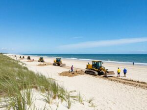 Renourishment activities on Myrtle Beach with machinery and beach workers.