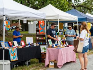 Artisans displaying handcrafted goods at the SEWE event in Charleston.