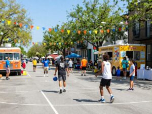 A lively community event in Charleston with streetball, food trucks, and families.