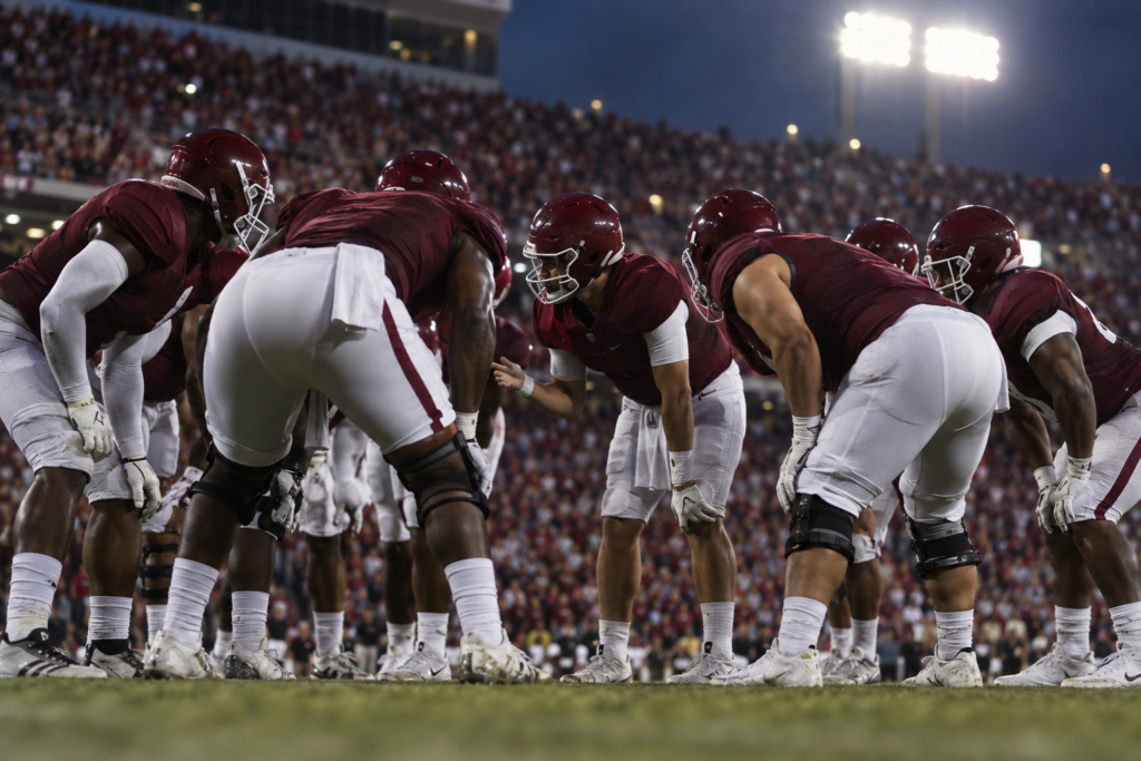 American football team huddle in garnet jerseys generic