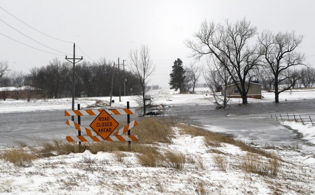Road closed sign beside a rural road